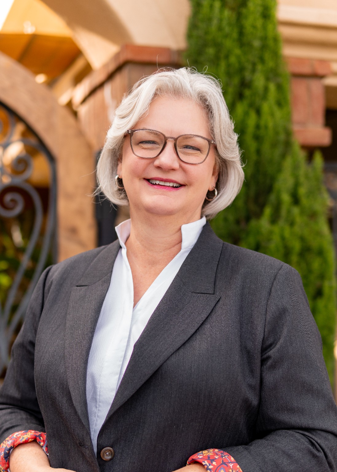 Lisa K. King smiling in a charcoal blazer, outdoors